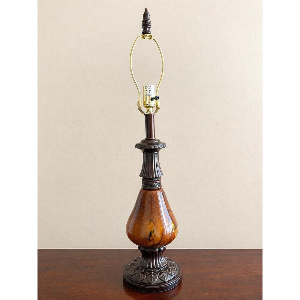 vintage Hollywood Regency style table lamp featuring a amber-colored glass base